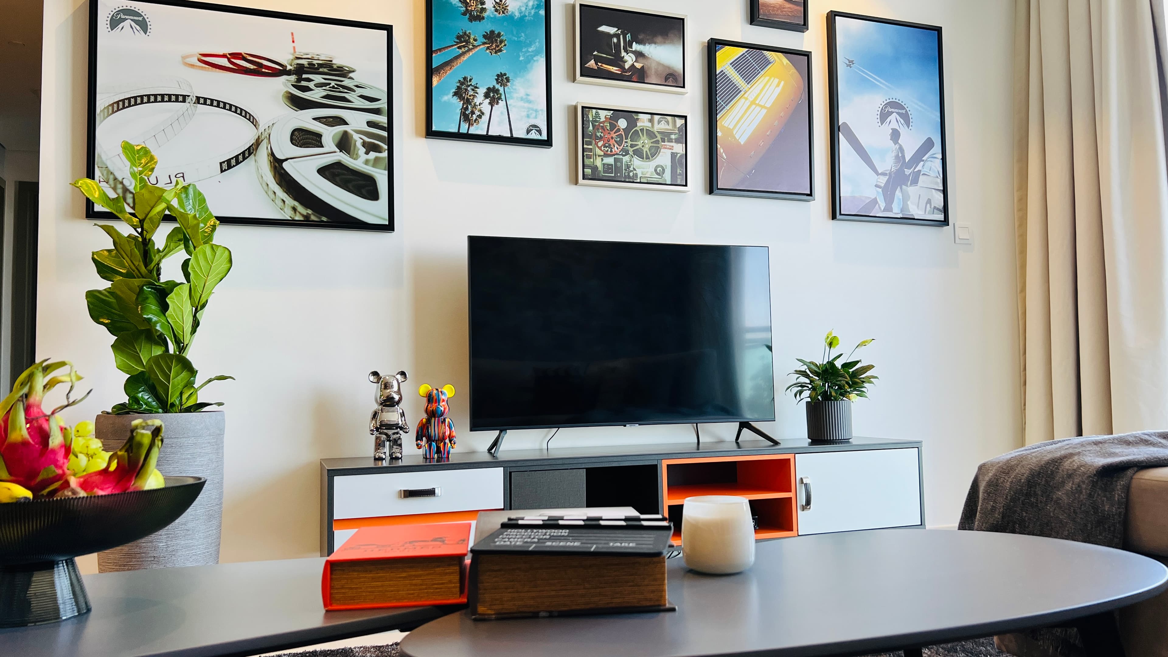 Living room with a Hollywood-themed gallery wall inside a Paramount Homes residence
