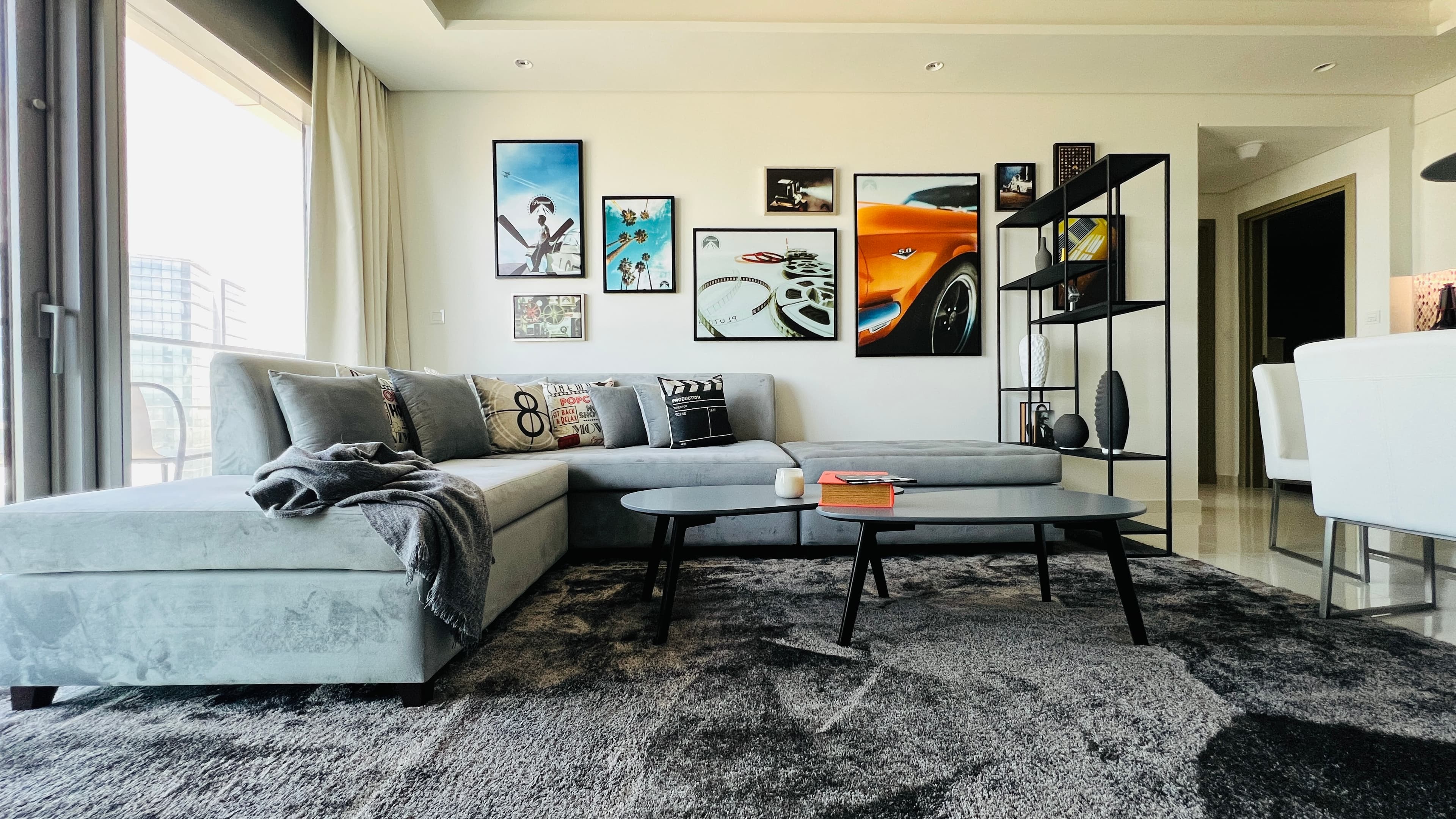 Living room with velvet sectional and Hollywood gallery wall